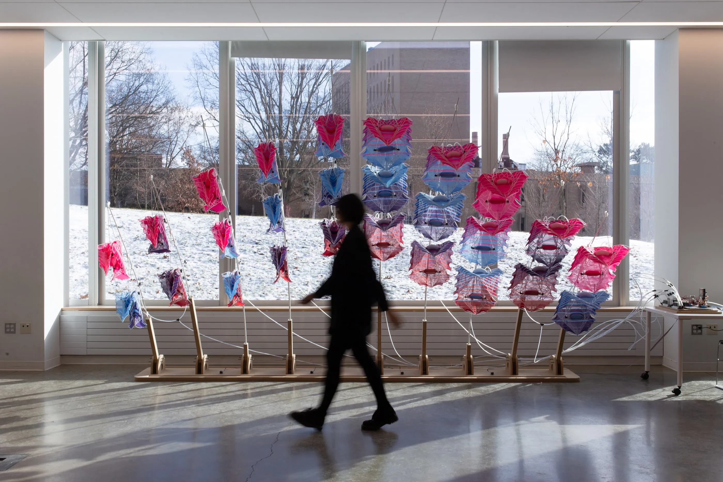 A visitor walking past the installation