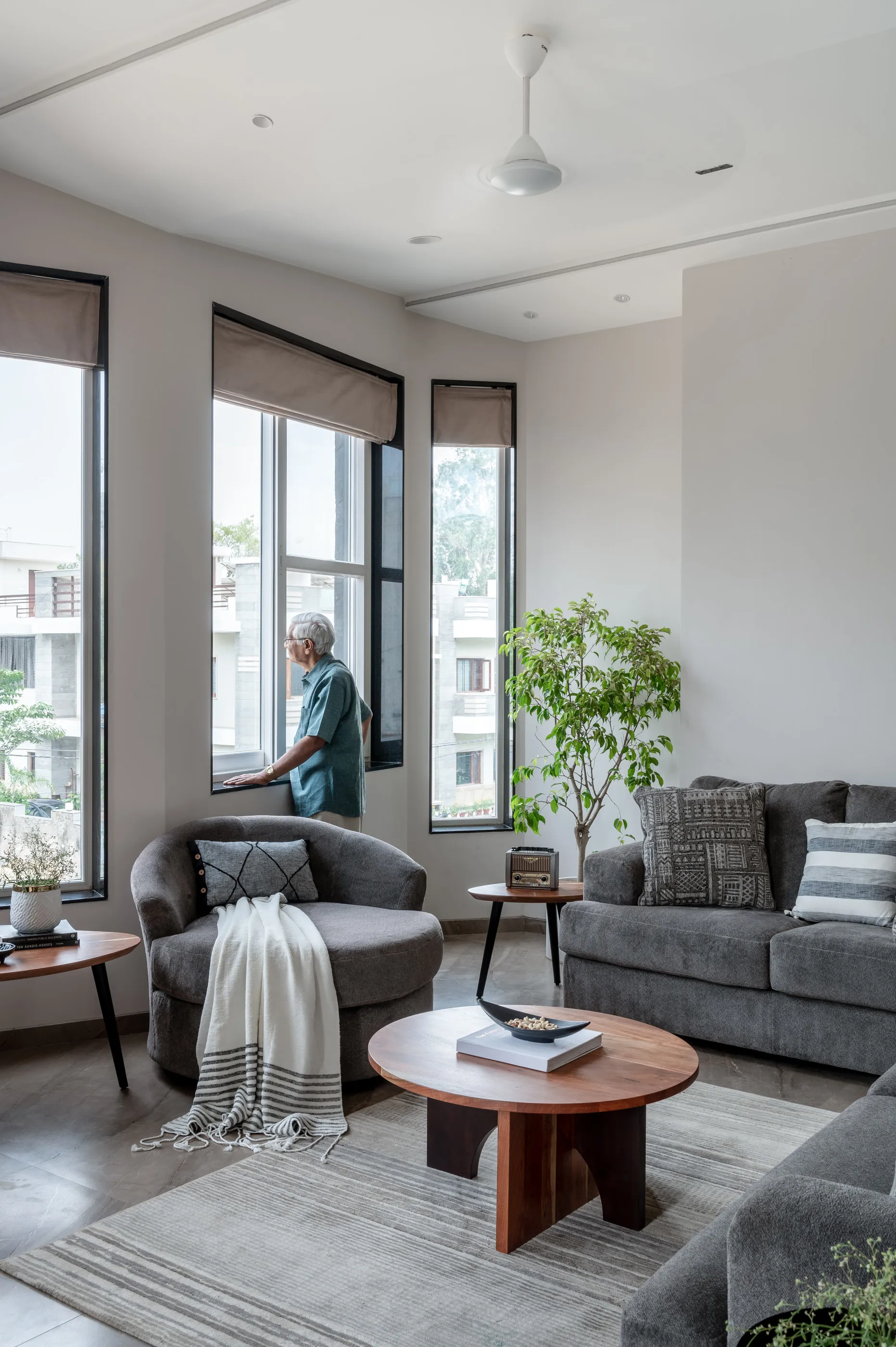 The living room with a round timber table and a view out